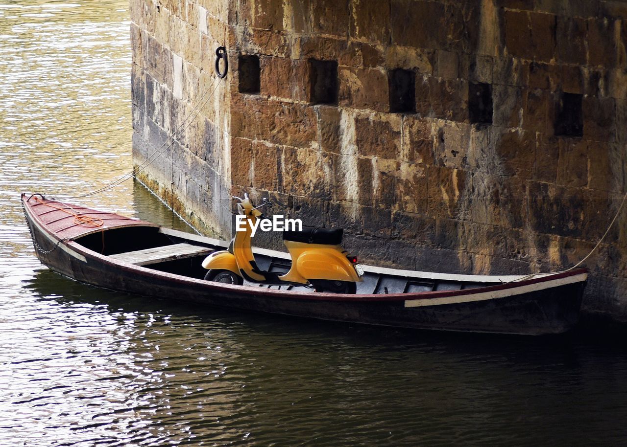 MAN IN BOAT AGAINST BUILDING