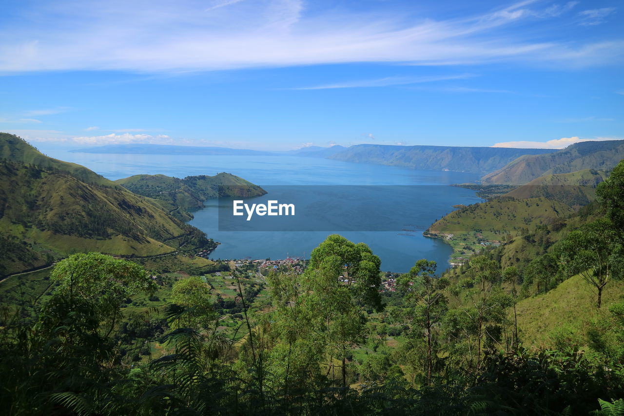 Scenic view of sea and mountains against sky