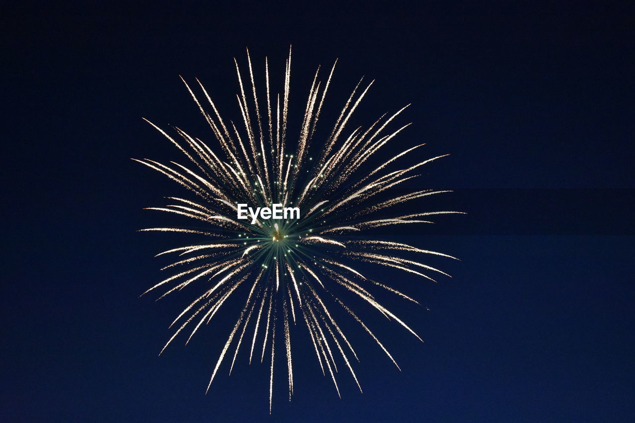 Low angle view of fireworks in clear sky at night
