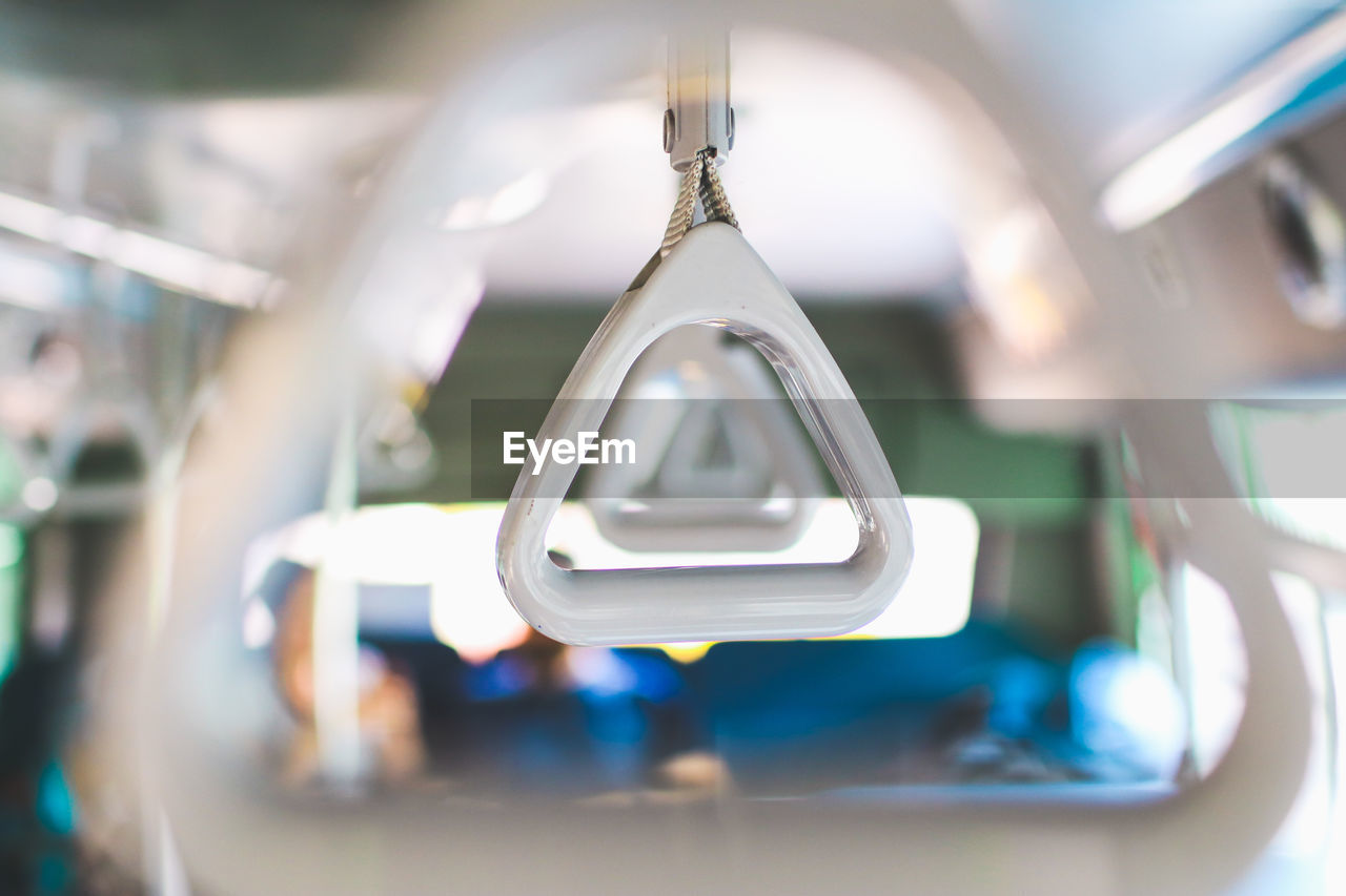 CLOSE-UP OF ELECTRIC LAMP HANGING IN EMPTY BUS