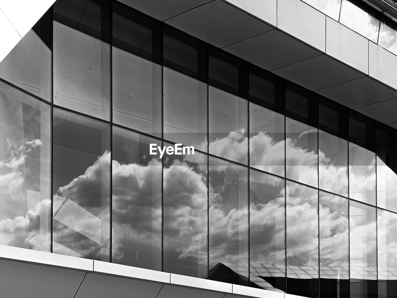 LOW ANGLE VIEW OF GLASS BUILDING