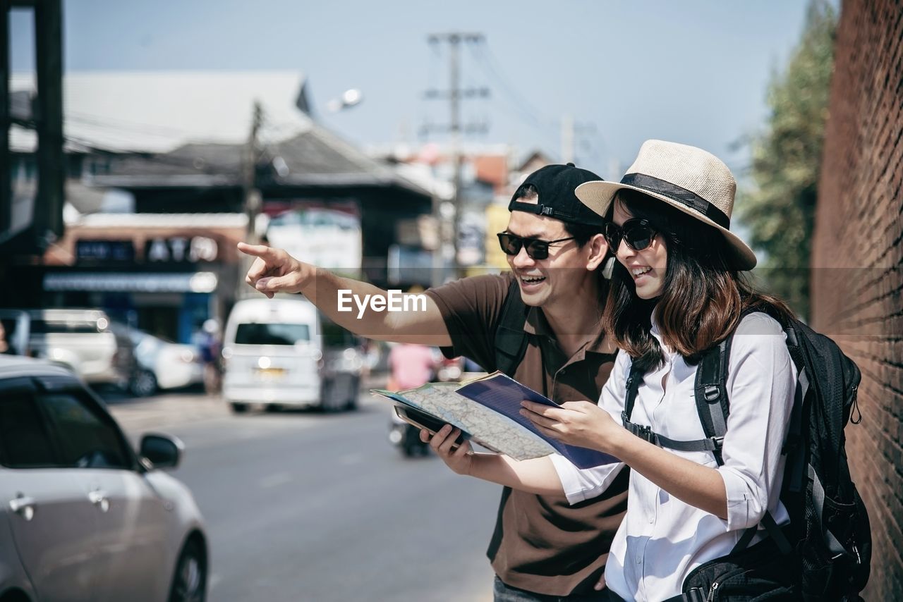 WOMAN USING MOBILE PHONE ON STREET