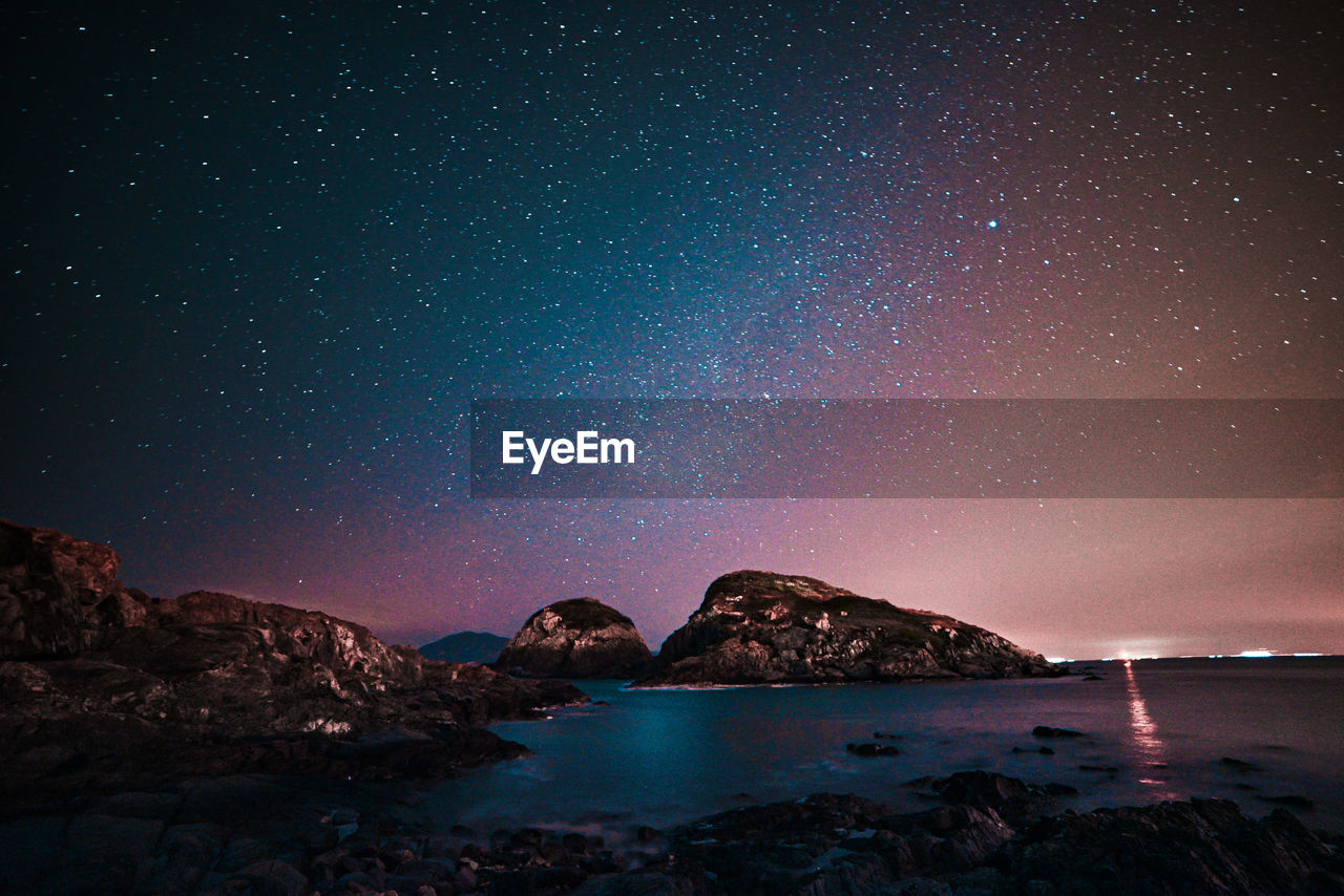 Scenic view of sea against sky at night