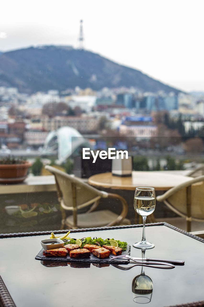 HIGH ANGLE VIEW OF FOOD ON TABLE IN CITY