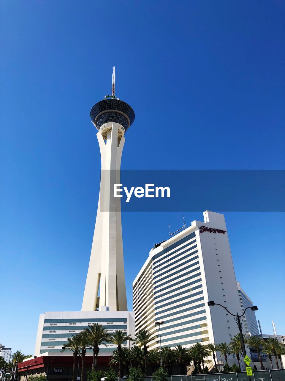 LOW ANGLE VIEW OF MODERN BUILDINGS AGAINST BLUE SKY