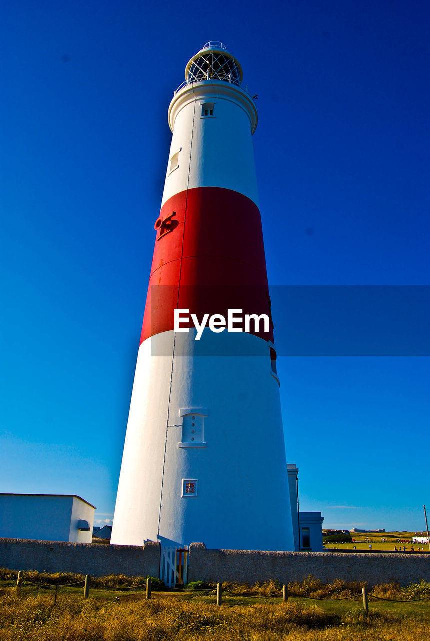 Low angle view of lighthouse against blue sky