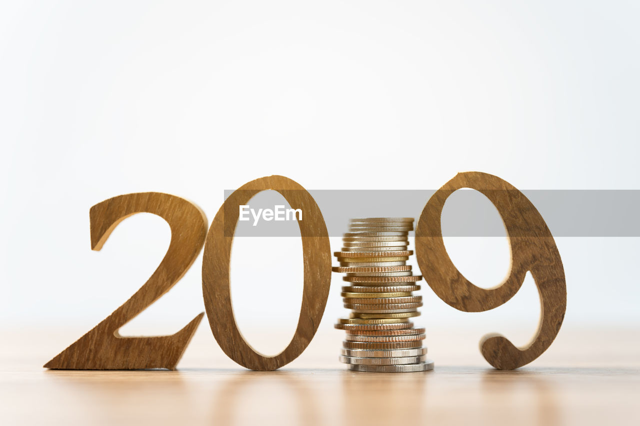 Close-up of coins and numbers on white background