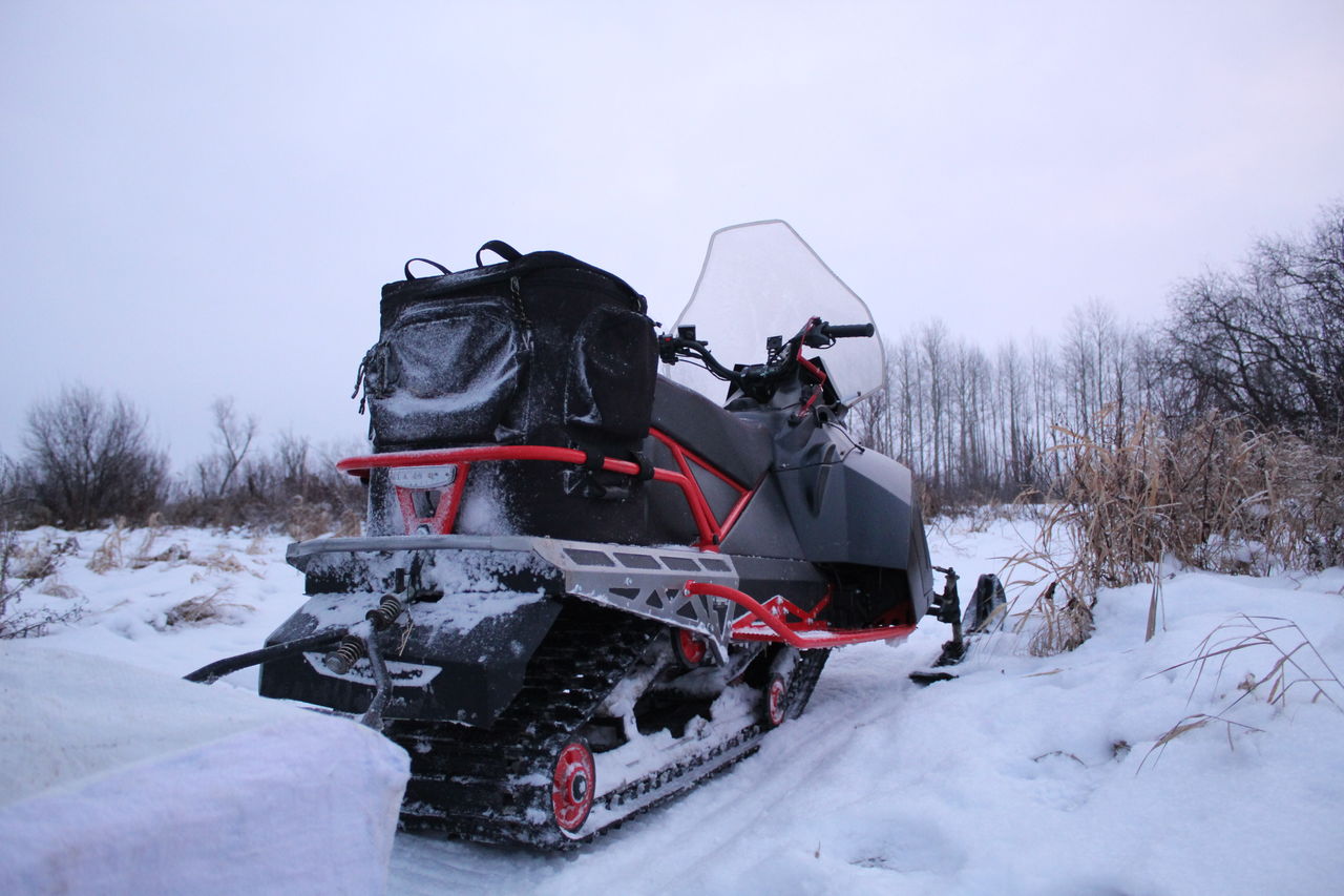 TRACTOR ON SNOW COVERED LAND