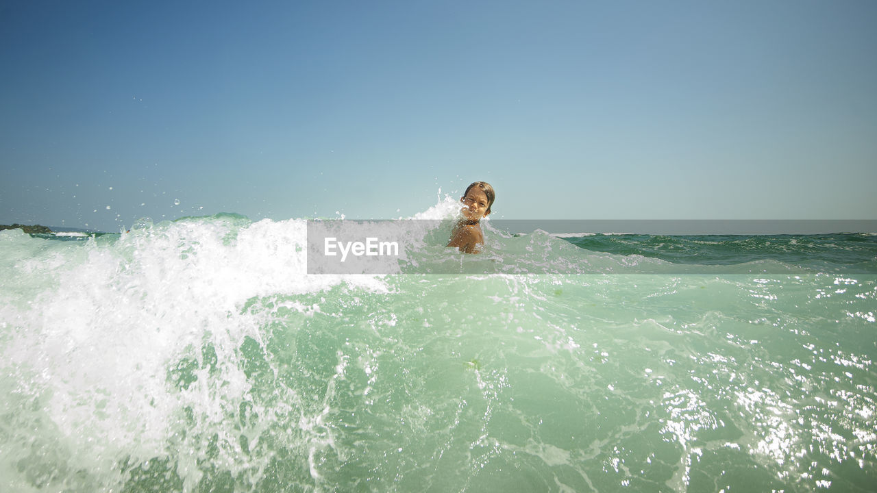 man swimming in sea