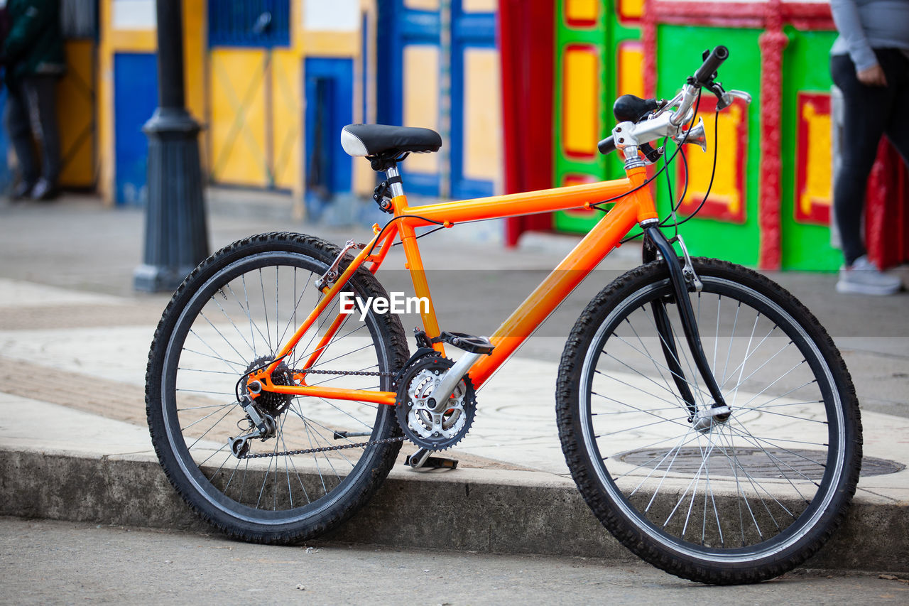 Orange bicycle parked at the colorful streets of of the small town of salento  in colombia