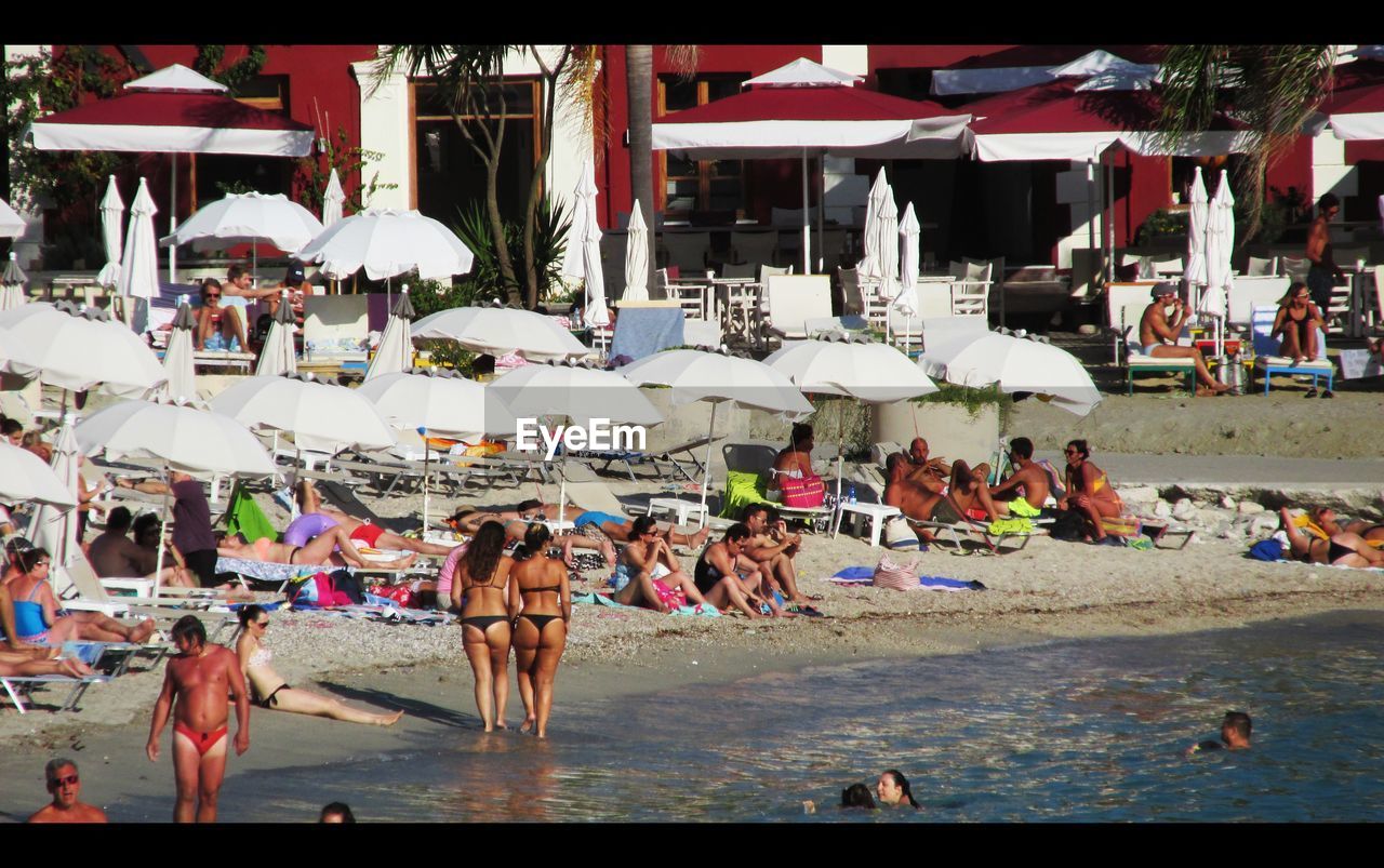 PEOPLE STANDING IN FRONT OF RIVER