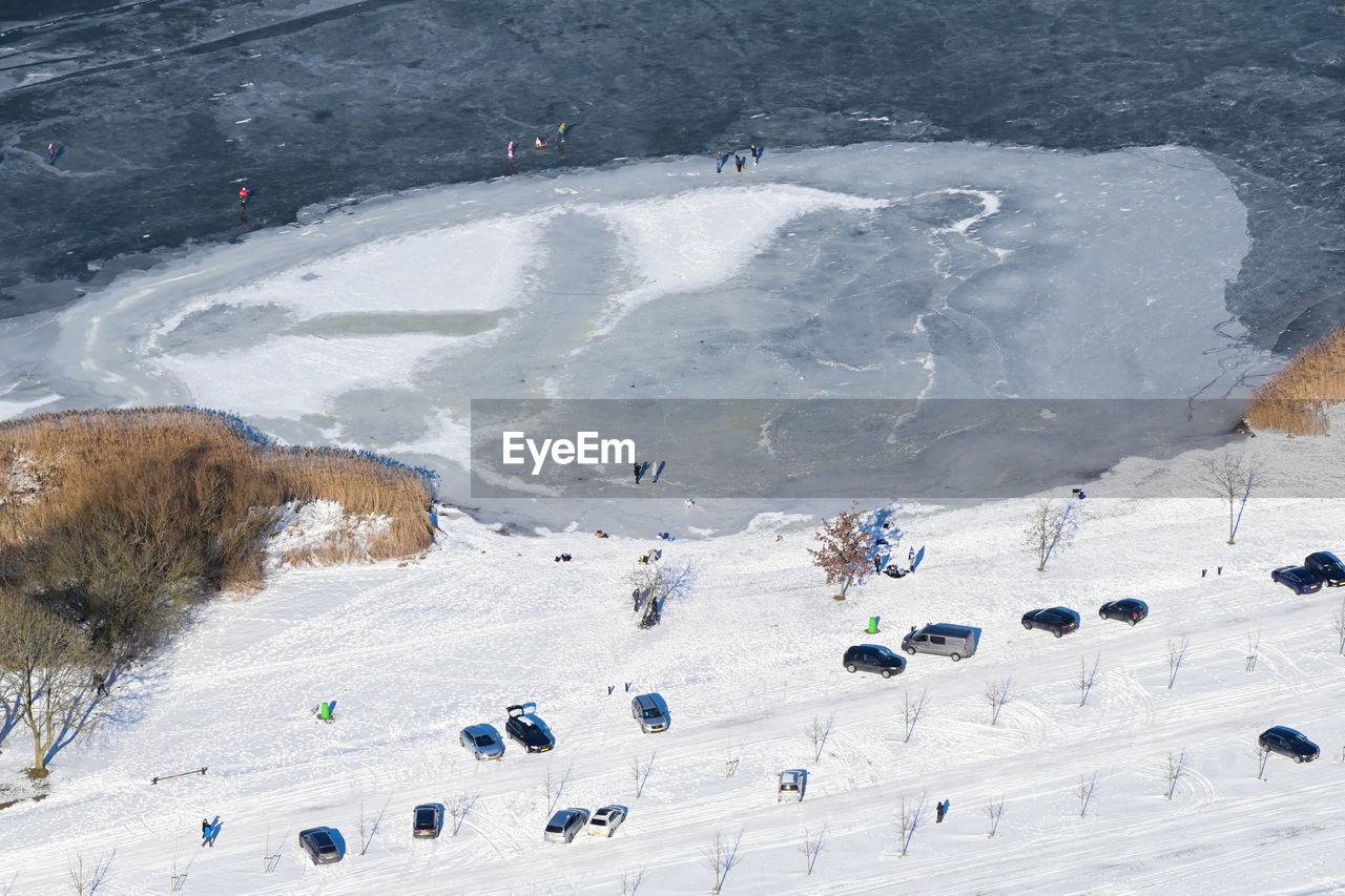 HIGH ANGLE VIEW OF PEOPLE ON SNOW