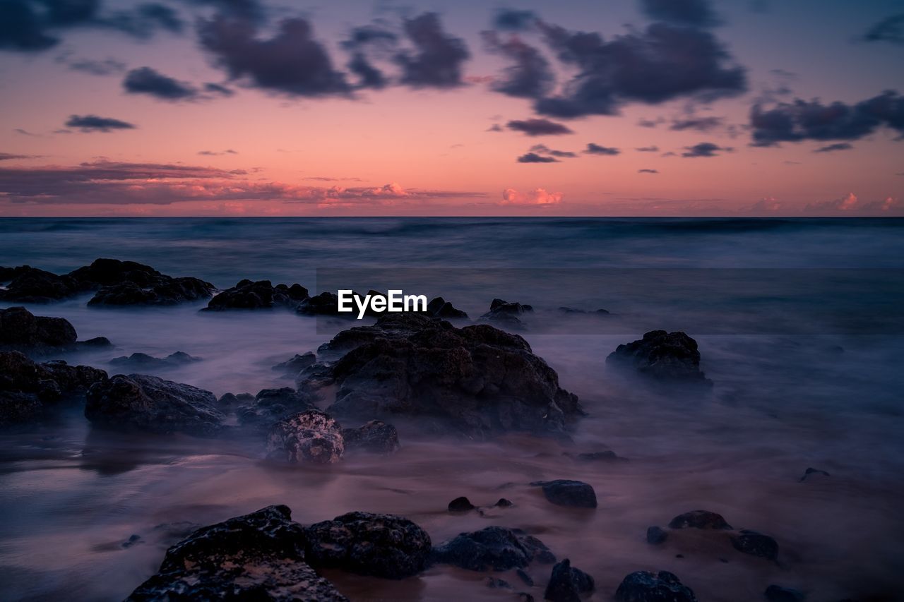 Scenic view of sea against sky at sunset