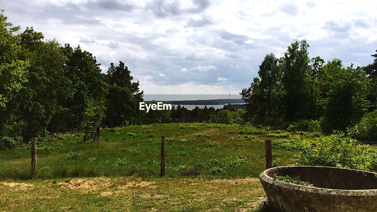 Scenic view of landscape against cloudy sky