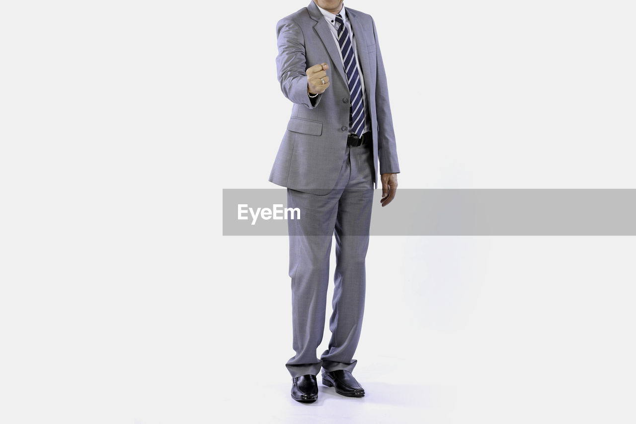 formal wear, one person, full length, clothing, adult, studio shot, men, business, businessman, pocket, indoors, outerwear, white background, copy space, tuxedo, footwear, standing, dress shirt, business finance and industry, cut out, occupation, sleeve, full suit, person, coat