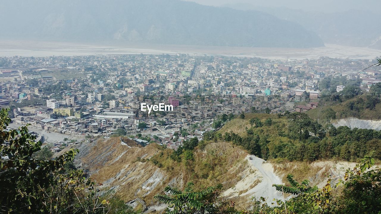 HIGH ANGLE VIEW OF CITYSCAPE AND MOUNTAINS