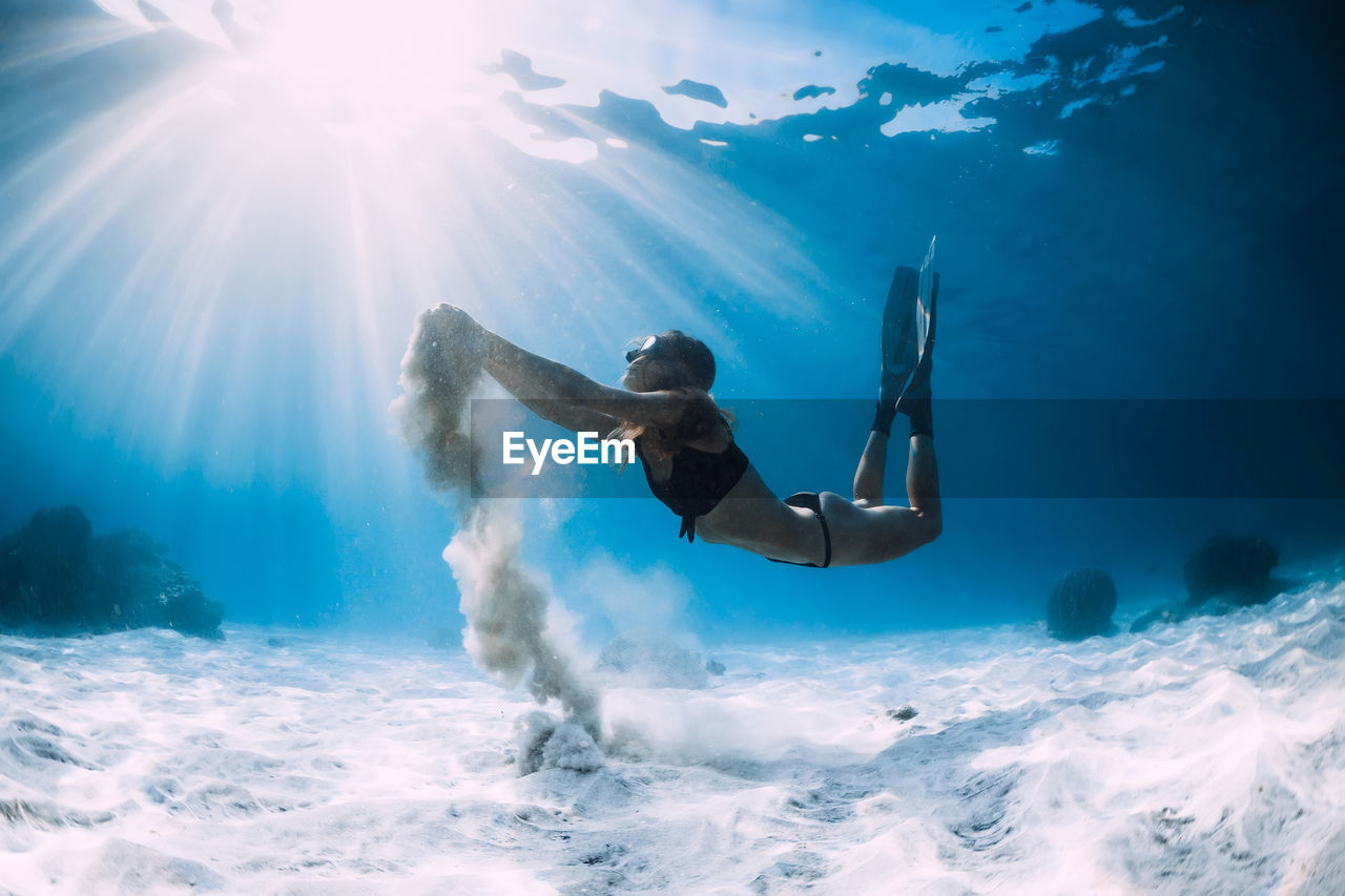 low angle view of woman swimming in sea