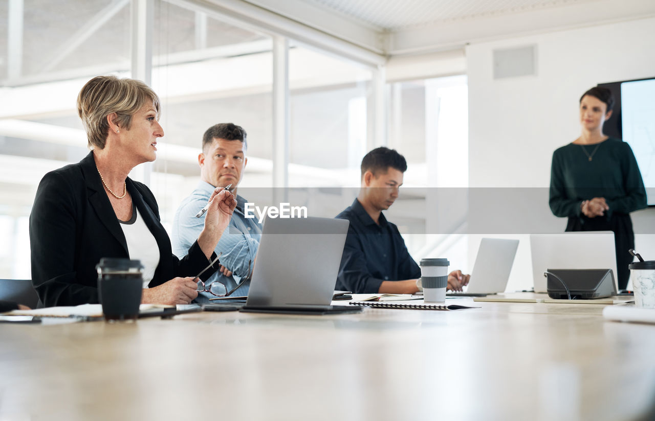 A businesswoman having a meeting in the boardroom with her team. a female leader at a presentation