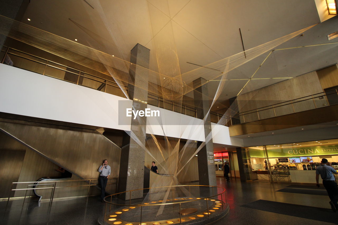 PEOPLE WALKING IN MODERN BUILDING