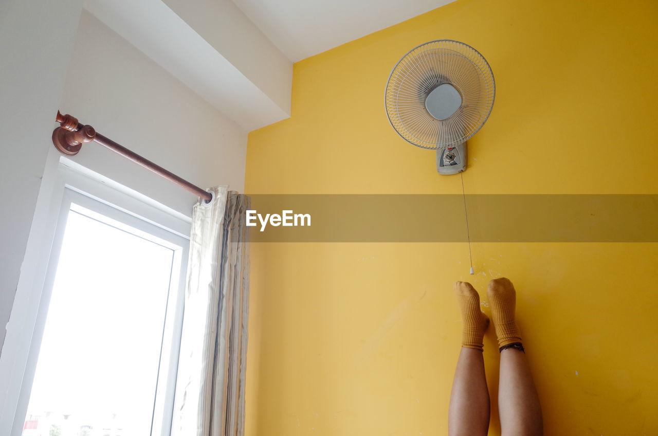 Low angle view of feet up on the wall