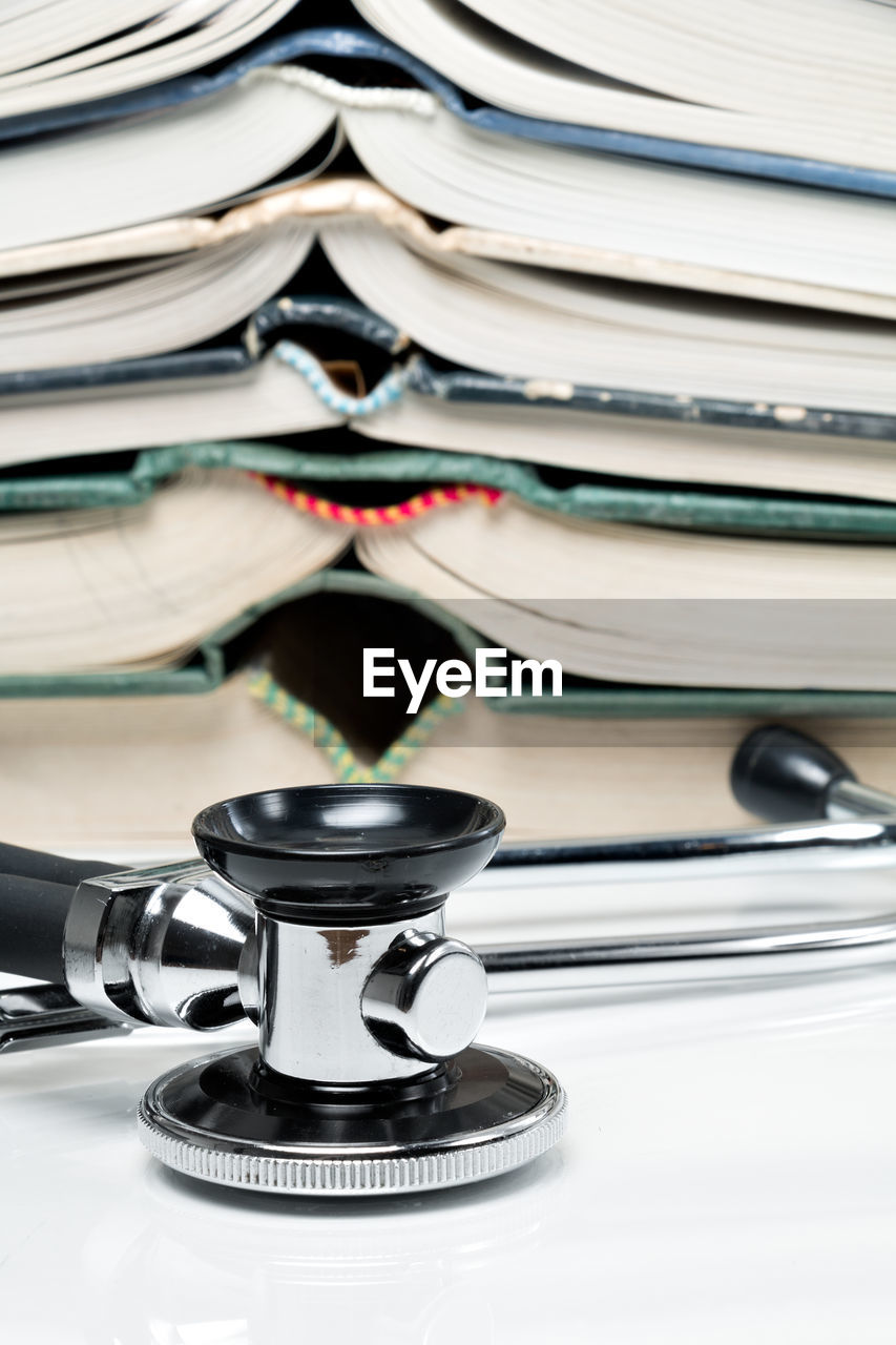 CLOSE-UP OF STACK OF BOOKS ON SHELF