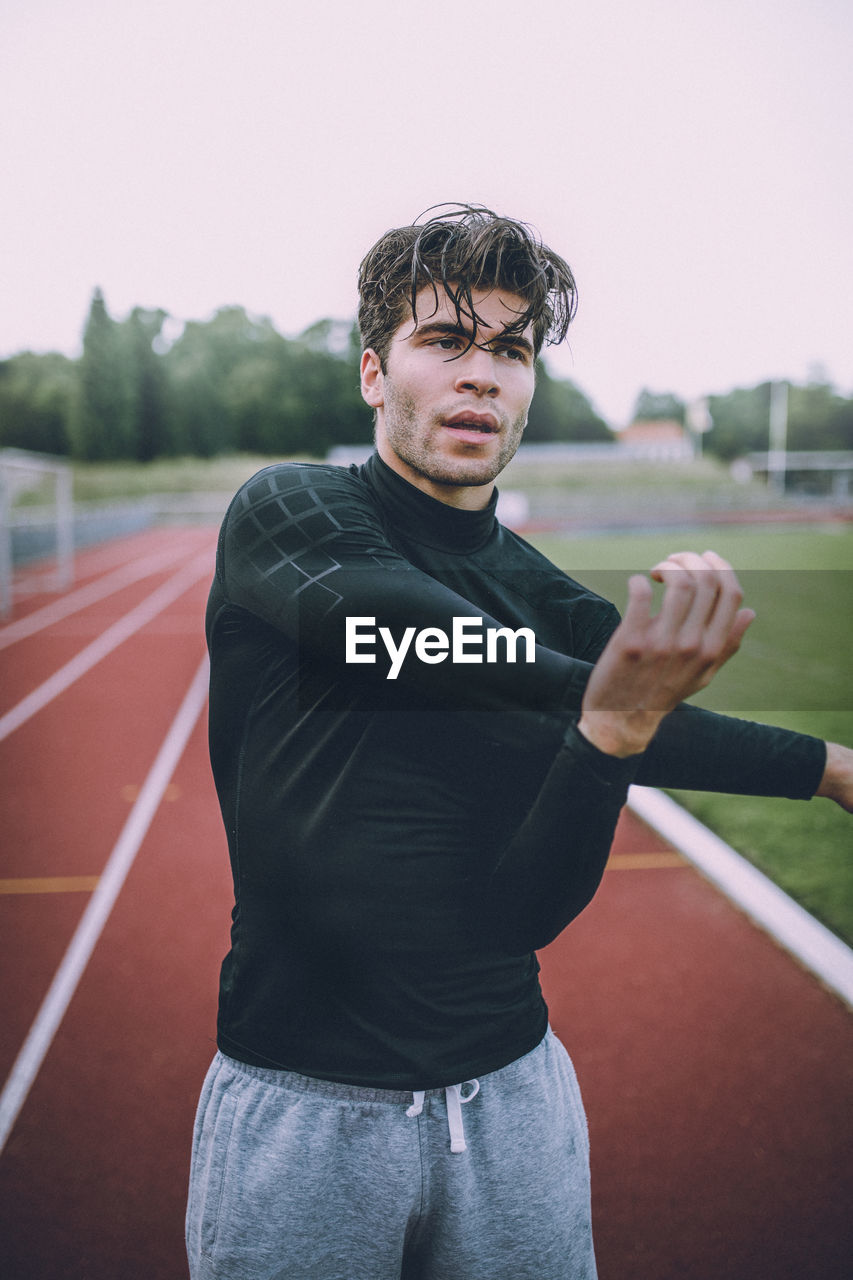 Young man practicing on running track