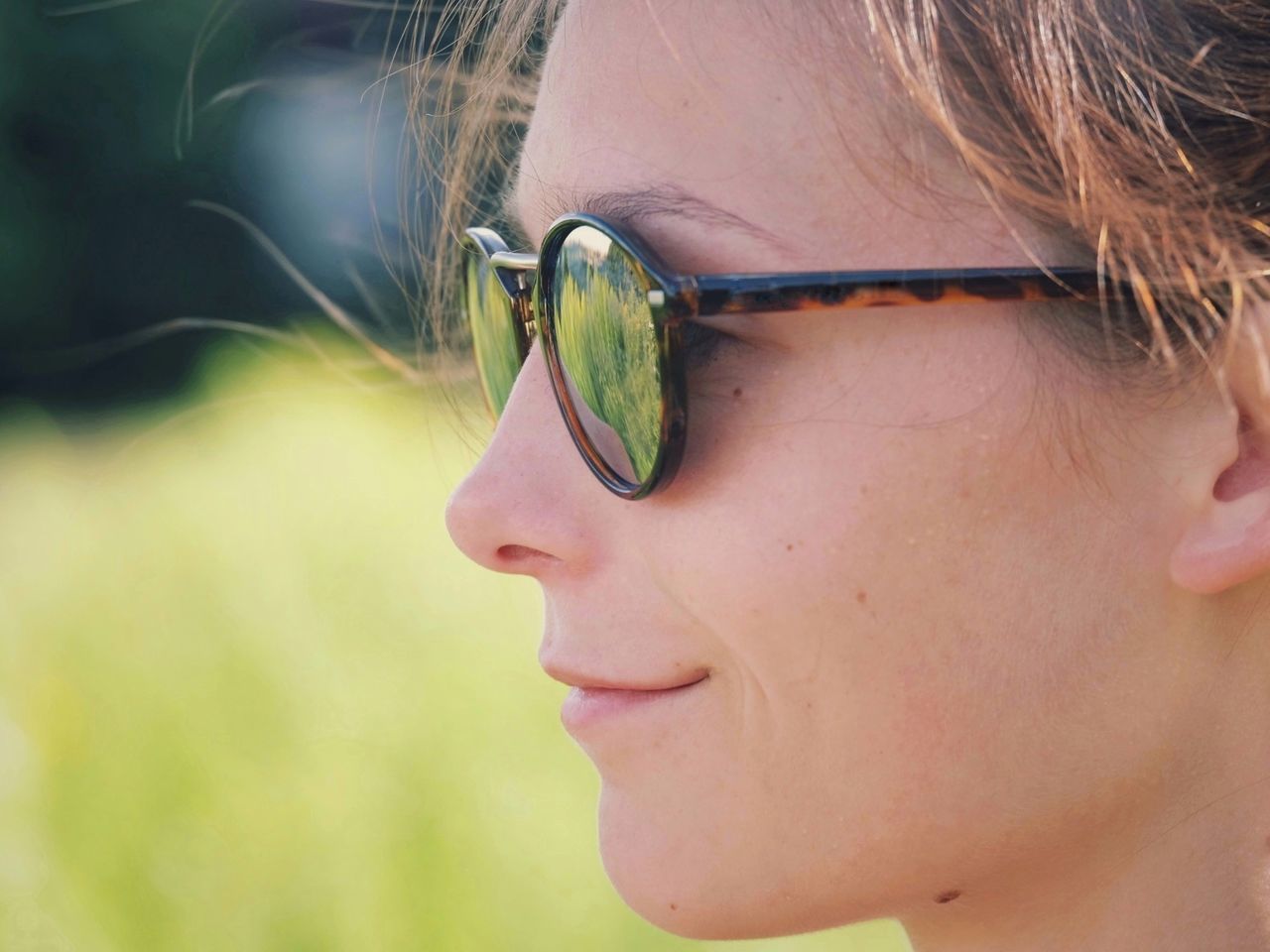 Profile view of young woman wearing sunglasses
