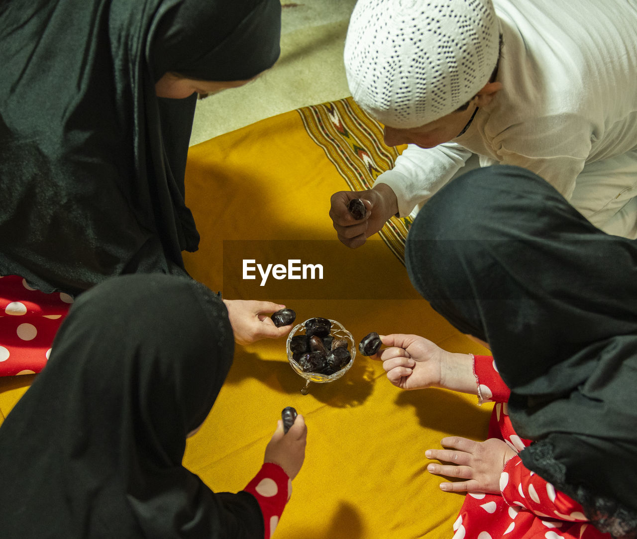 High angle view of people eating dates