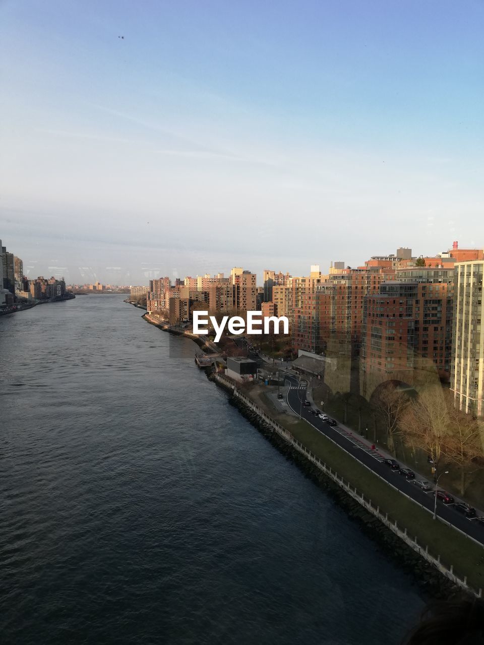 High angle view of river amidst buildings in city against sky