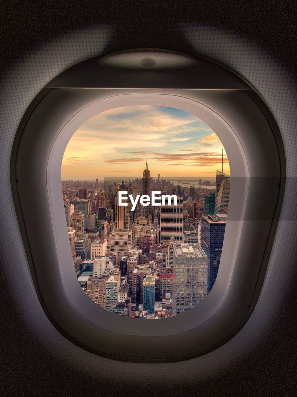 New york cityscape against sky seen through plane window