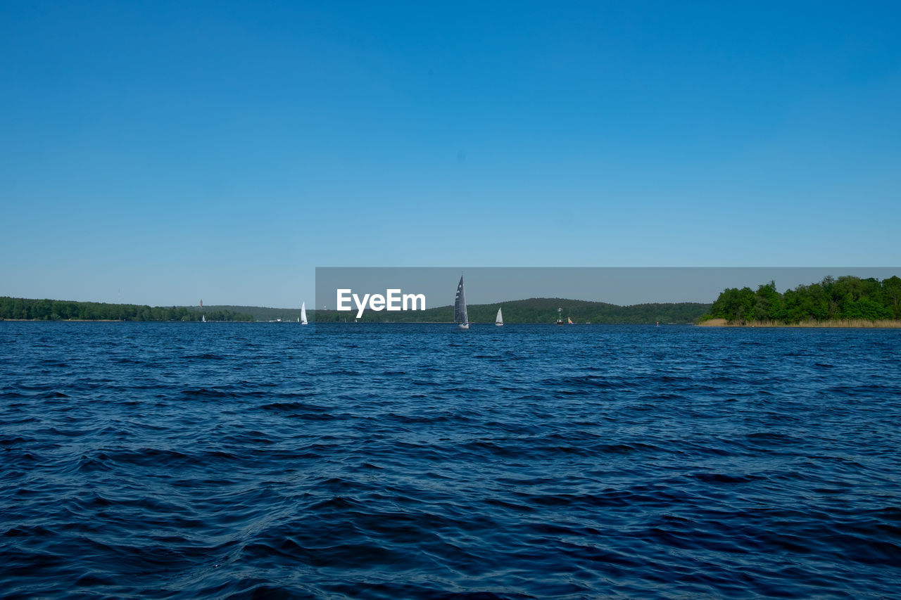 SCENIC VIEW OF BLUE SEA AGAINST CLEAR SKY