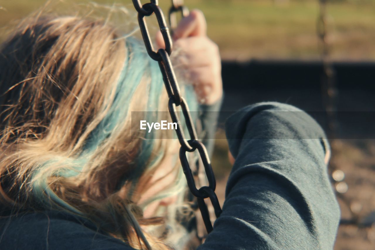 Close-up of woman on swing