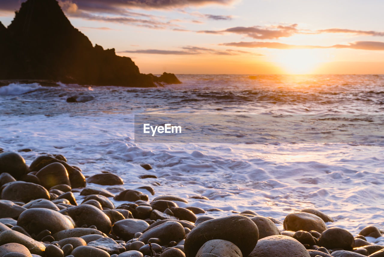 Scenic view of sea against sky at sunset