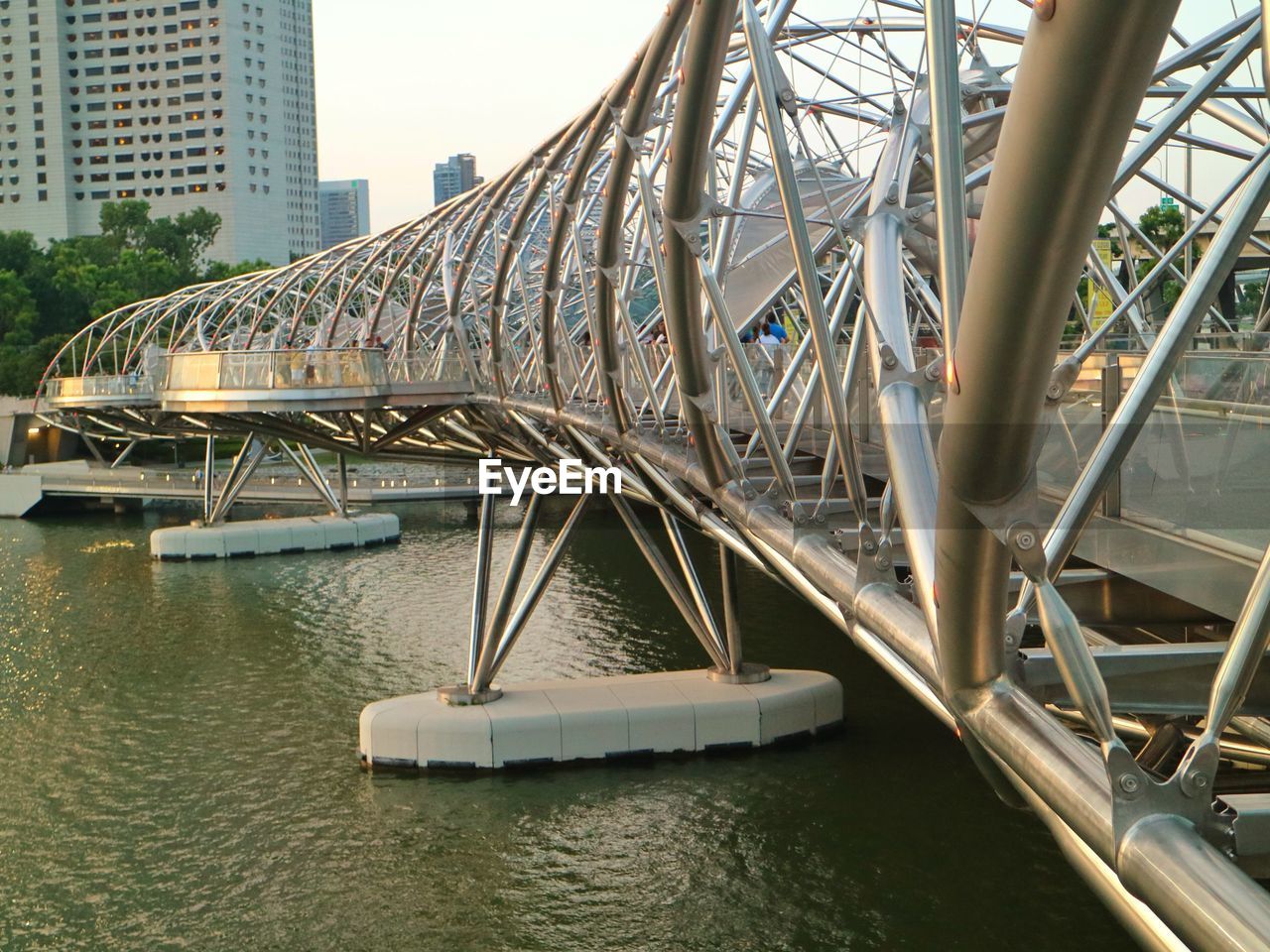 Bridge over river against buildings in singapore 