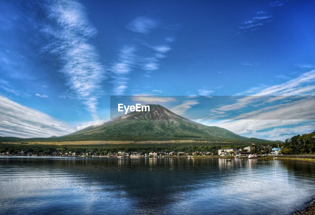 Scenic view of lake with mt fuji against blue sky. 