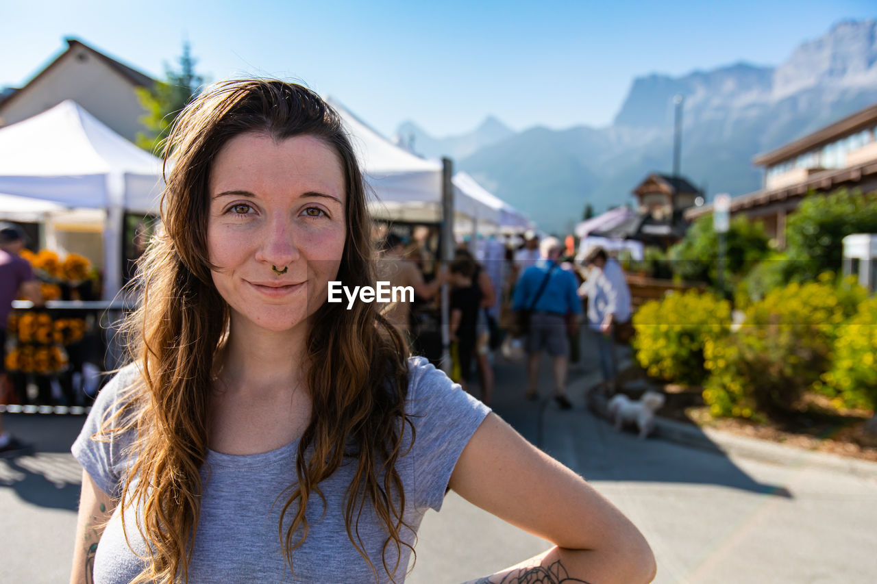 Portrait of woman against market