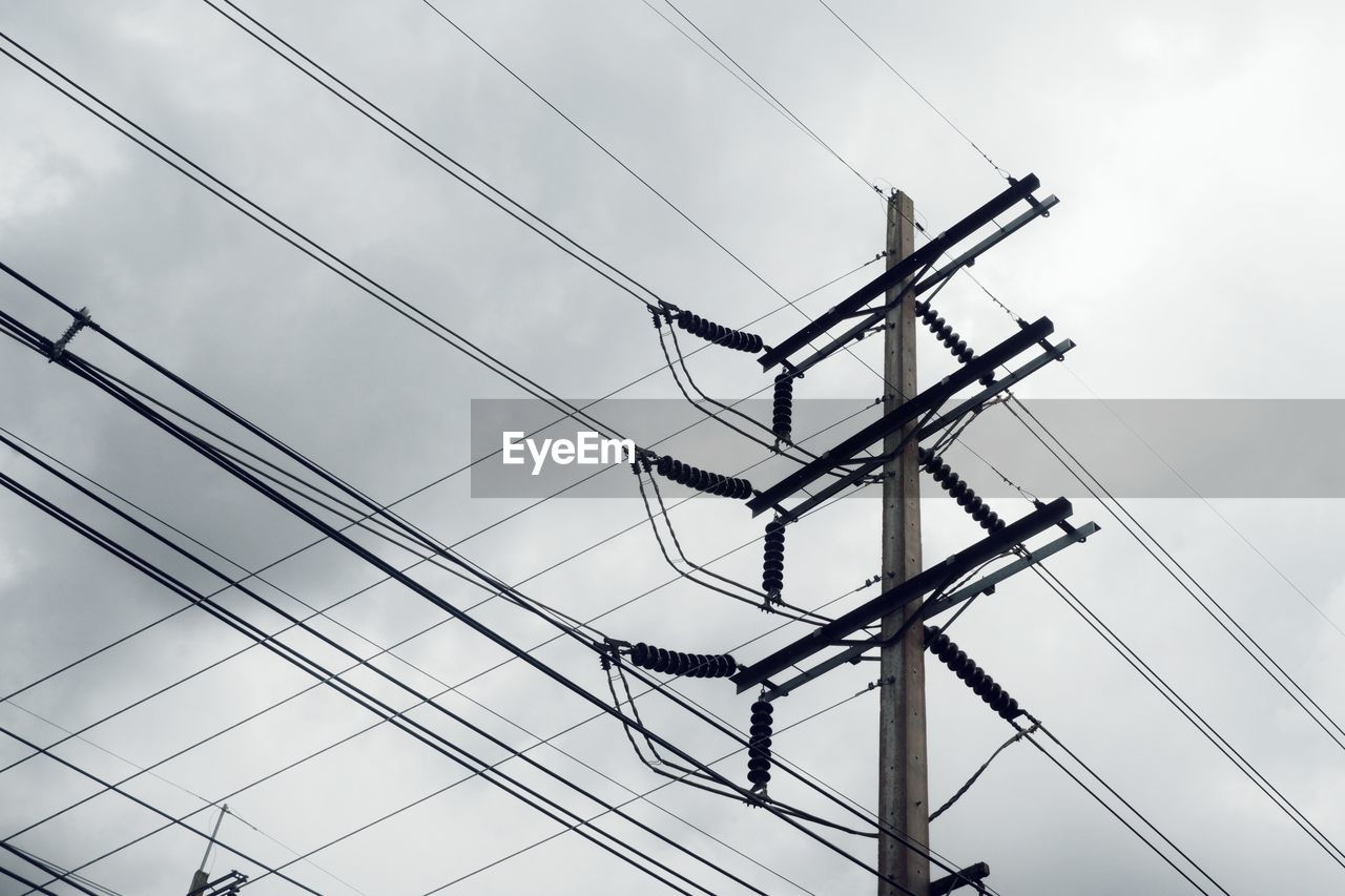 Low angle view of electricity pylon against sky