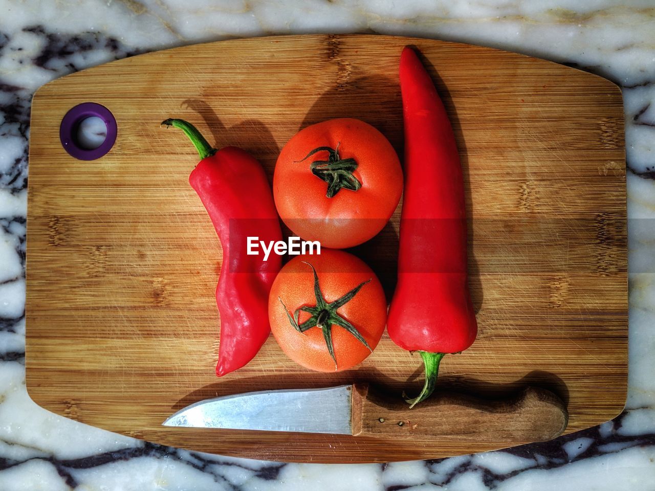 High angle view of red chili peppers on cutting board