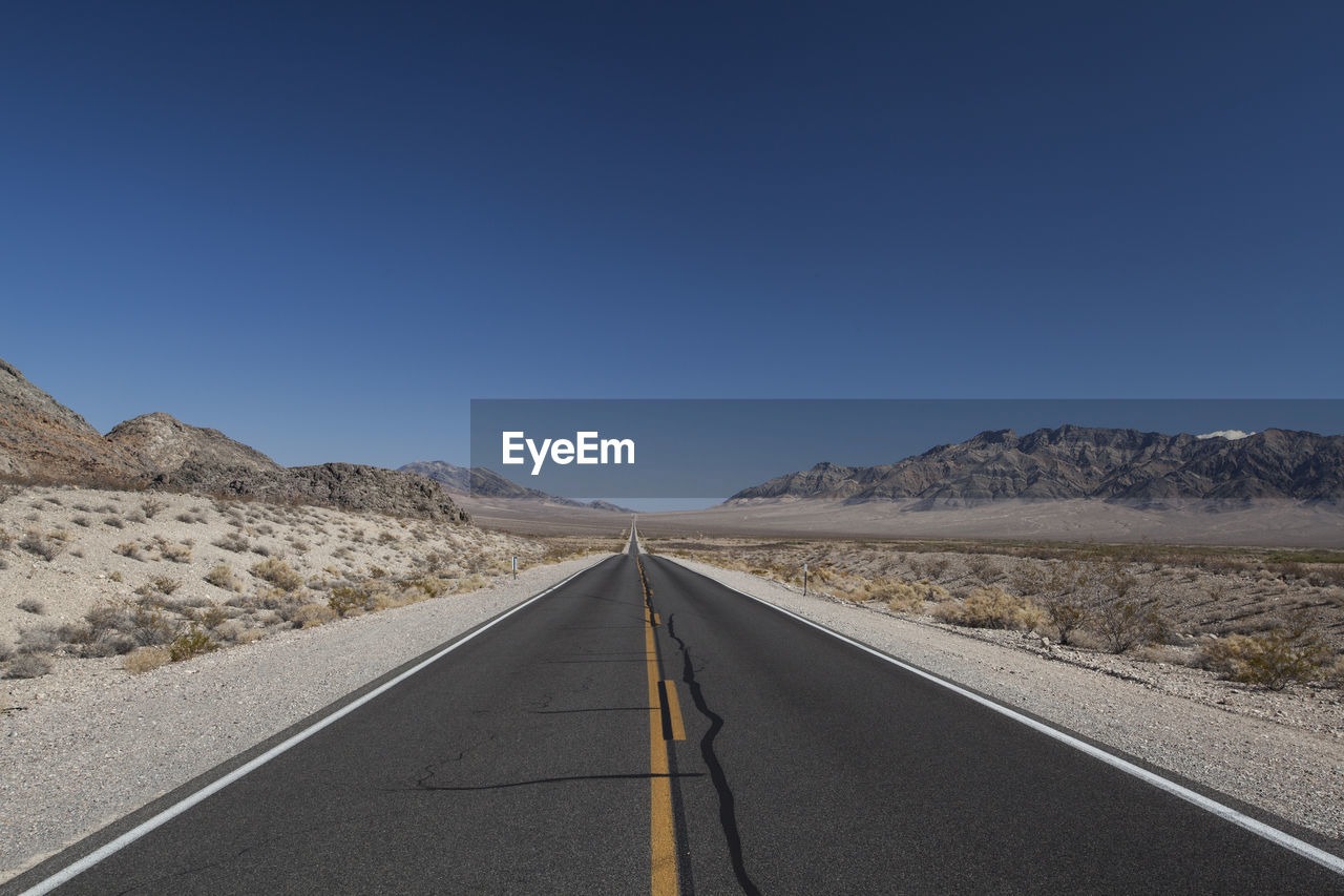 Road in desert against clear sky