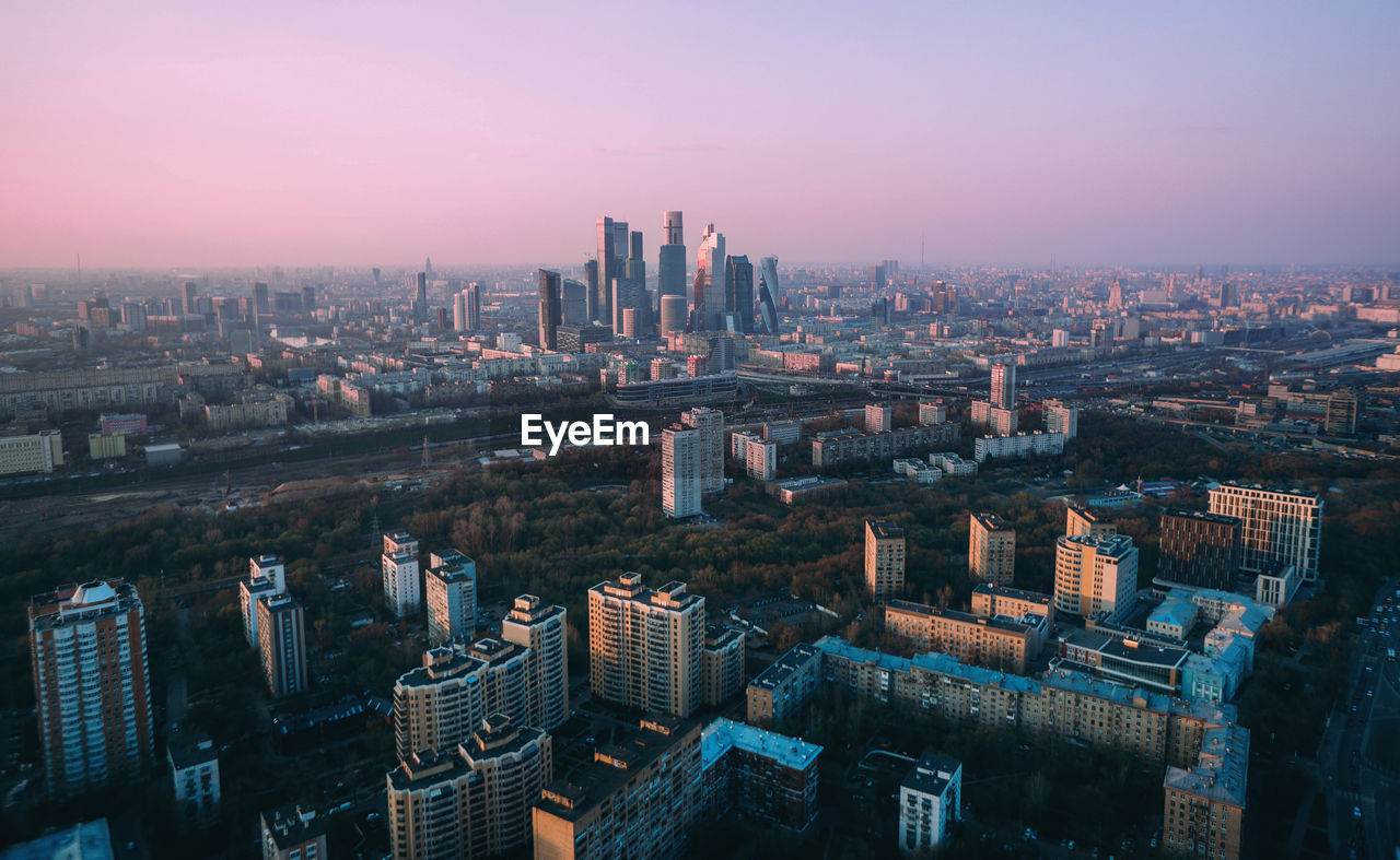 AERIAL VIEW OF BUILDINGS IN CITY AGAINST SKY