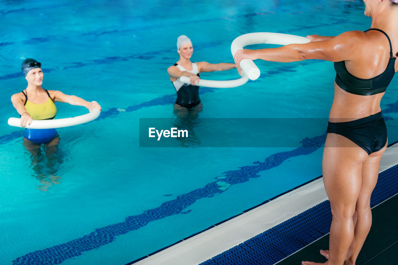 Female swimmers exercising in swimming pool