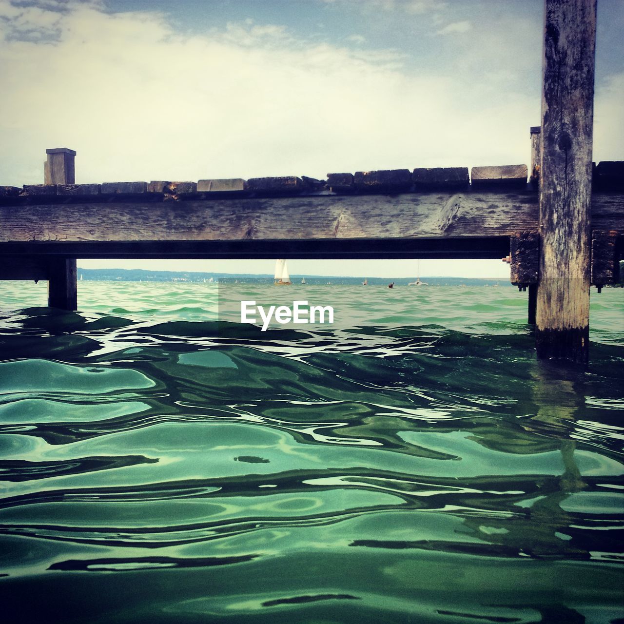 Low angle view of wooden jetty over rippled water