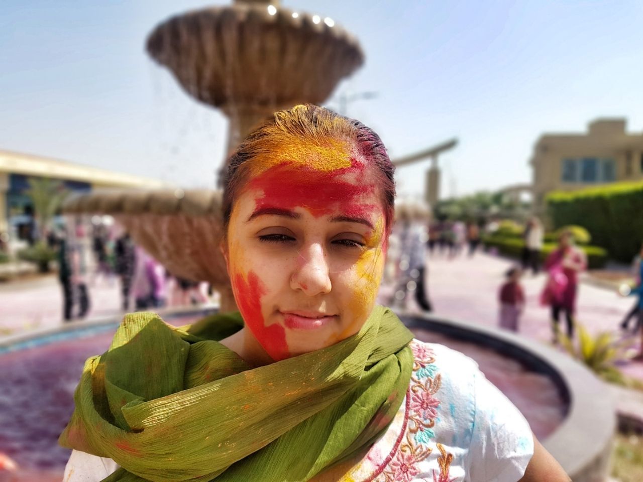 Portrait of woman with face powder during holi outdoors
