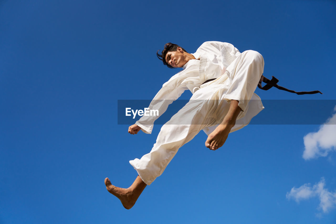 Low angle view of man practicing karate