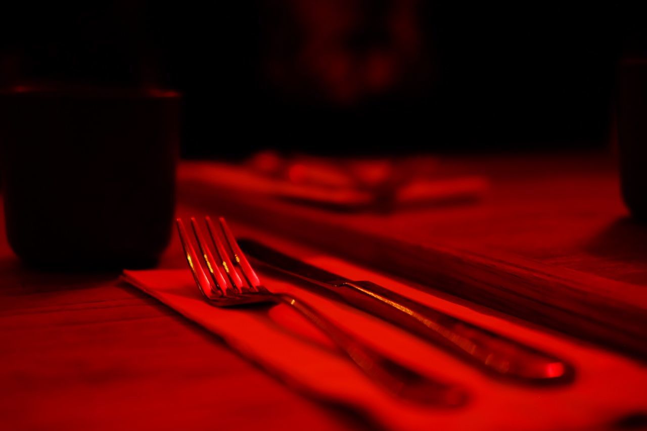 CLOSE-UP OF RED WINEGLASS ON TABLE