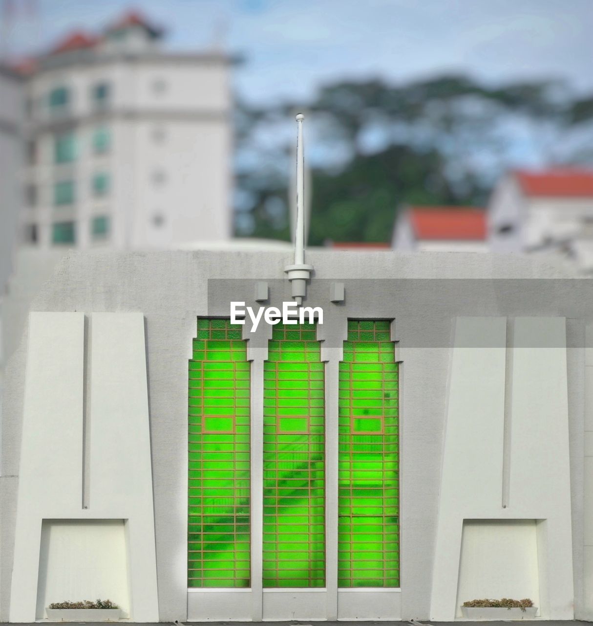 CLOSE-UP OF MULTI COLORED BUILDING BY WATER