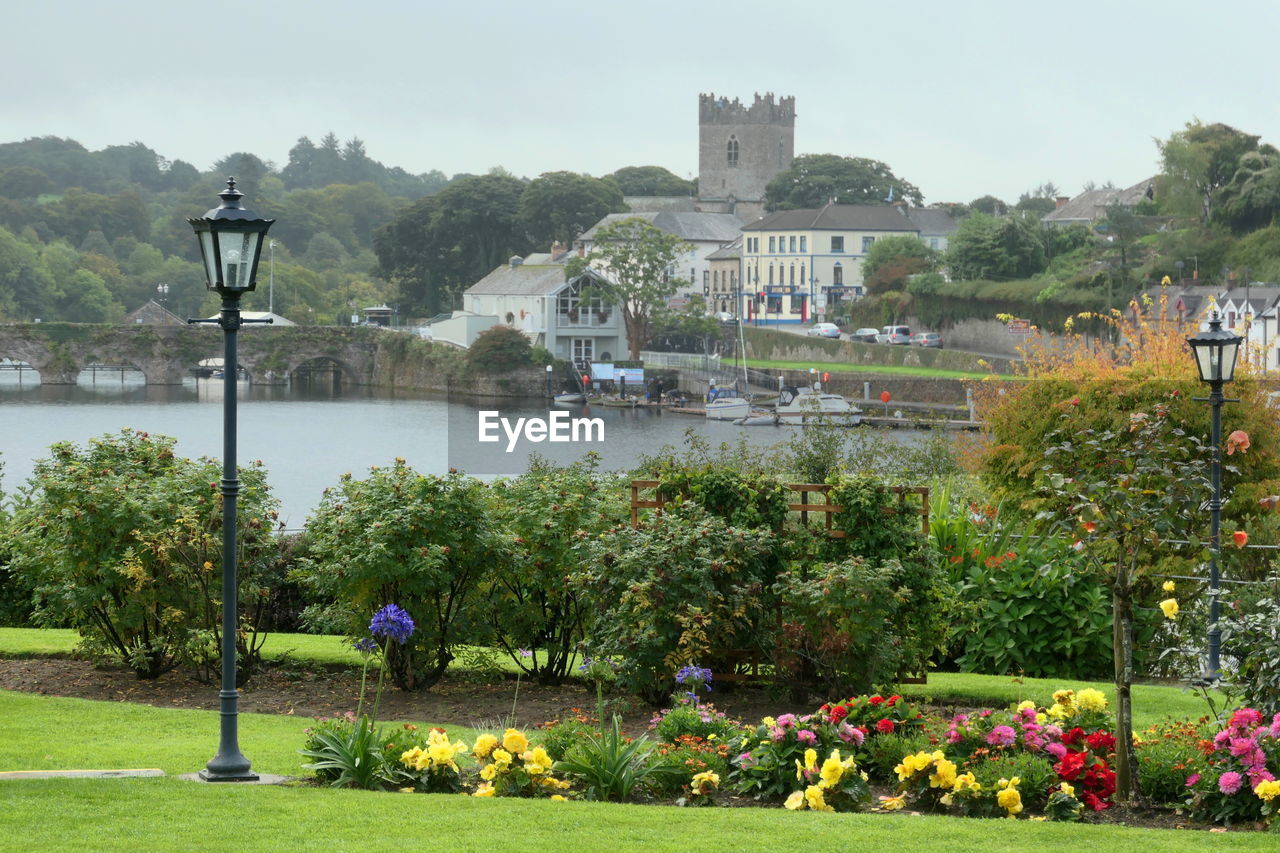 Scenic view of castle across garden and lake