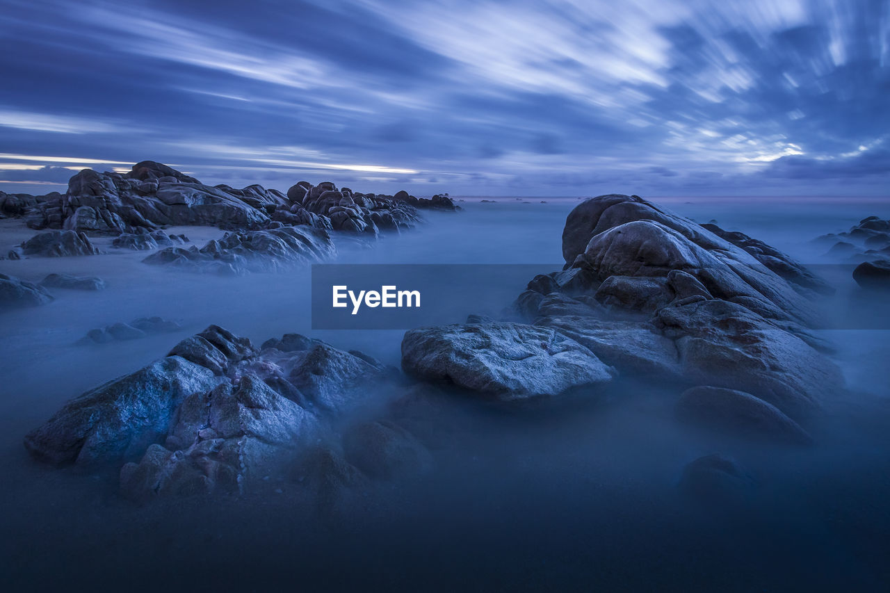 Scenic view of rocks against sky during winter