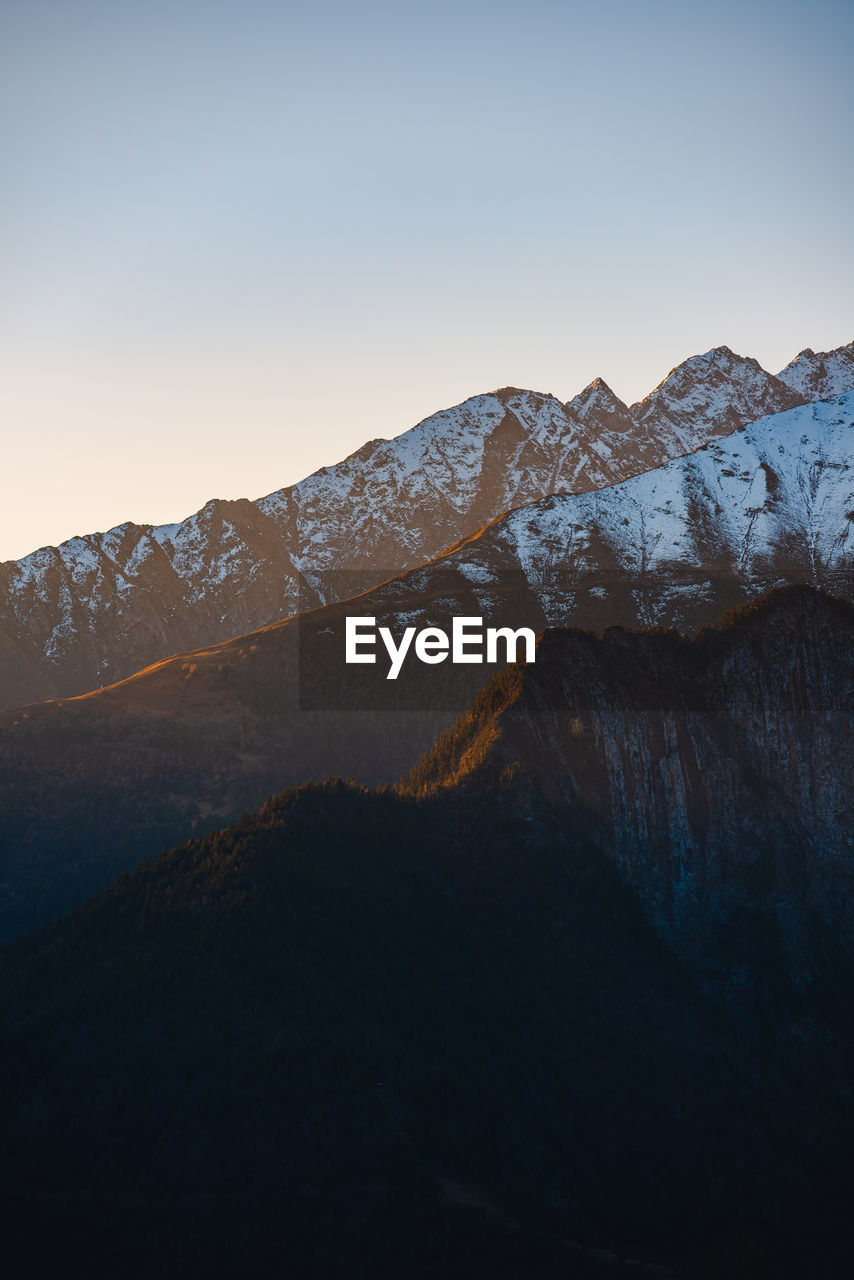 Scenic view of snowcapped mountains against clear sky