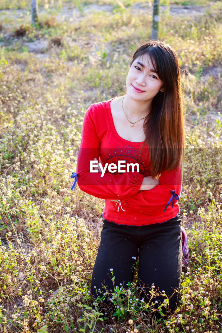 BEAUTIFUL YOUNG WOMAN STANDING ON LAND IN SUNLIGHT